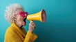 ©  Shomixer - Profile view of an elderly woman with curly white hair, dressed in a yellow sweater using a yellow megaphone against a blue background.