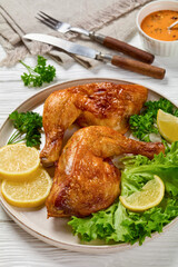 Canvas Print - fried chicken legs with lettuce, lemon on plate