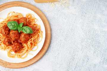 Wall Mural - Plate of boiled pasta with tomato sauce and meat balls on white table