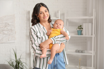 Wall Mural - Young woman with her baby at home