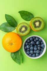 Poster - Orange, blueberry and kiwi isolated on  pastel background