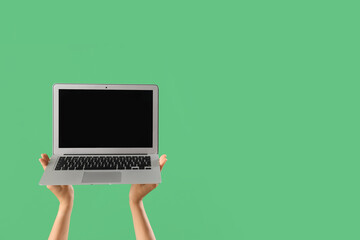 Wall Mural - Woman with blank laptop on green background