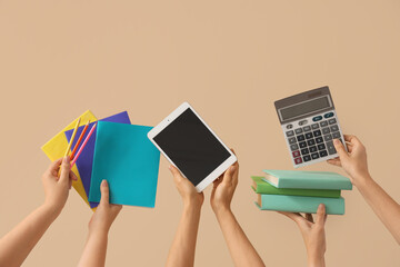 Wall Mural - Women with blank tablet computer, books and calculator on beige background