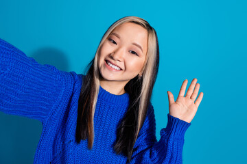 Wall Mural - Photo portrait of pretty young girl selfie photo wave hand hello wear trendy knitwear outfit isolated on blue color background