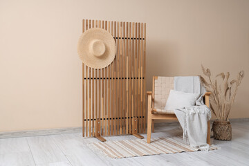 Sticker - Stylish interior of living room with cozy armchair, vase of pampas grass and folding screen