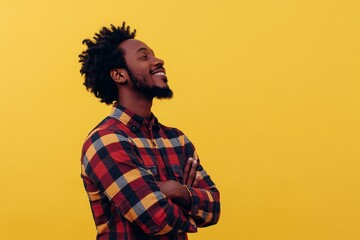 A portrait of a smiling African American man with a confident expression, wearing a checkered shirt and standing against a bright yellow background. He symbolizes positivity, success, and a hopeful ou