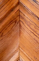 Buffed lime pine wood grainin the form of a herringbone. Wooden background.