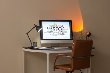 Sticker - Workplace with modern computer and glowing lamp in stylish office at evening. SEO concept