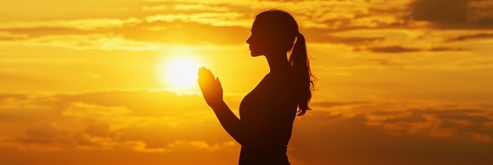 A woman stands silhouetted against a vibrant sunset, her hands raised in a gesture of prayer, symbolizing faith, hope, and the pursuit of spiritual connection. The setting sun represents the end of on