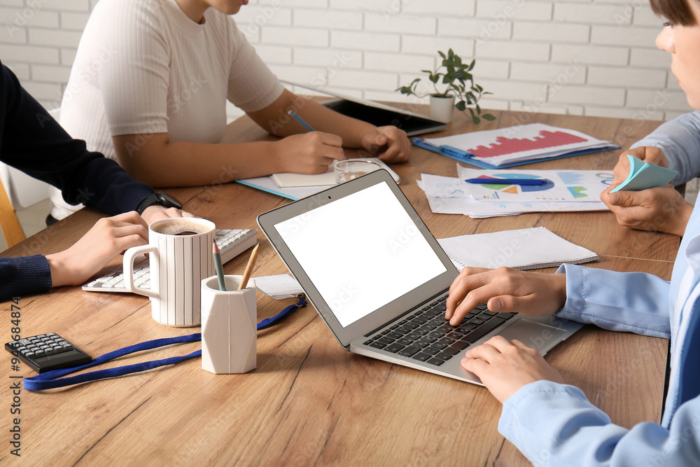 Business team working with laptop during meeting in office, closeup