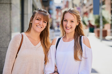 Friends, women and happy in city for portrait, outing and reunion in Australia. Sisters, love or smile on sidewalk for journey, bonding and ready for shopping with relationship development or support