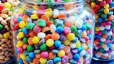 A high-resolution image of a glass jar filled with colorful candies