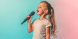 © SnowElf - Cute child girl singing into a microphone on a simple colored pastel background with copy space. Banner template