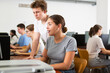 © JackF - Teenage boy and girl using computer at college library, watching videos