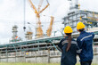 © CandyRetriever  - Man and woman petrochemical engineer teamwork meeting discussion at petroleum oil refinery industry area. Industrial factory technician worker working maintenance manufacturing energy power gas system