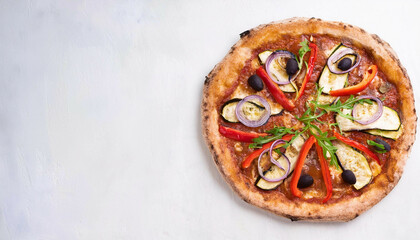 Top view of a pizza topped with grilled zucchini, red bell peppers, black olives, red onions, and arugula, served on a round crust, placed on a light background. Copy space on the left.