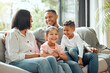 © KayJoint/peopleimages.com - Family, smile and living room sofa with bonding, parent love and care in home. Lounge, relaxing and children with mom and dad happy with hug and comfort on couch with mother and father together