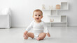 © Sean - Adorable baby smiling and sitting in a white onesie mockup