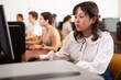© JackF - Portrait of fifteen-year-old schoolgirl studying at computer in a class at an informatics lesson with classmates