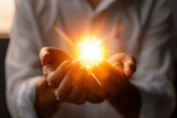 The Spark of Innovation: A close-up of a person's cupped hands, radiating a brilliant golden light, symbolizing creativity, potential, and the power of ideas. 