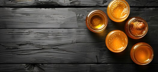 Honey Jars on Black Wooden Background