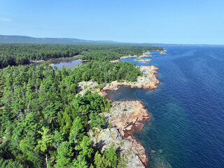 Aerial view of forest and rocky outcrop on the north shore of Lake Huron on a summer afternoon