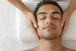 © Niks Ads - young indian man receiving facial massage in salon