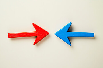 Red and blue arrows facing each other on beige background