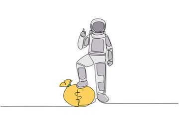 Wall Mural - continuous one line drawing astronaut stands with thumbs up pose and steps on money bag with one of 