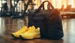 © TigerDude - Black gym bag with yellow sports shoes and water bottle on a wooden floor in a fitness club background.