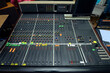 © Yurii Zushchyk - Buttons, levels, switches, speaker volume control on an audio mixer control panel set at the TV studio