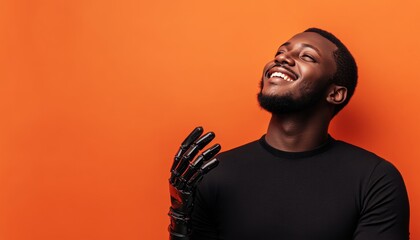 Joyful african american man with prosthetic hands poses against a vibrant orange background