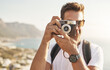 © Sanc/peopleimages.com - Sightseeing, portrait and man with camera for photography, document experience and capture picture of nature. Travel, photographer and memory with vintage equipment on vacation, holiday and outdoor