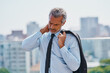 © StarDweller/peopleimages.com - City, tired or businessman with neck pain, stress or injury with stiff muscle tension or body discomfort. Outdoor, balcony or exhausted mature CEO with fatigue, workplace accident or physical burnout