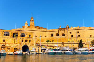 Wall Mural - Harbor of Senglea old town in Malta. Moored boats and old architecture of Malta