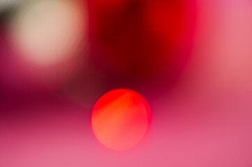 Abstract blurred background, red spot on pink gradient background.