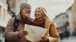 © fotofabrika - Elderly couple exploring a quaint European town while happily reviewing a map on a sunny day