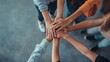 © fotofabrika - Group of hands joining together in unity amidst a supportive gathering indoors during daylight hours