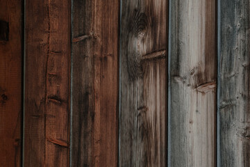 Detailed close-up of various wooden planks in different shades and textures showcasing natural wood grain patterns and colors in a rustic setting