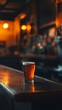 © Denys - Pint of beer sitting on bar top in busy pub