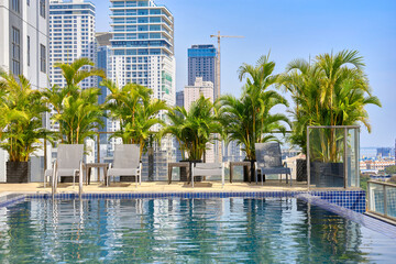 The rooftop pool of the hotel offers panoramic views of Phnom Penh Cambodia during the day.