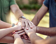 © Hira/peopleimages.com - Outdoor, motivation and closeup of people with hands together for teamwork, support and achievement. Friends, arms and trust with stack in park for collaboration, solidarity and agreement in unity