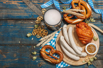 Wall Mural - Traditional Oktoberfest set. Pretzels, beer, weisswurst, eisbein with mustard. German festival food