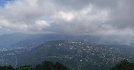 Wall Mural - A captivating cinematic image capturing a mountain range shrouded in foggy clouds above Baguio Philippines