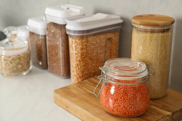 Wall Mural - Different types of cereals and legumes in containers on light table