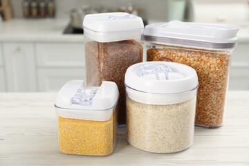 Wall Mural - Different types of cereals and legumes in containers on white wooden table in kitchen