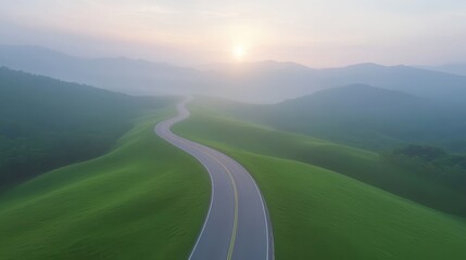 Wall Mural - A winding road with a beautiful sunset in the background