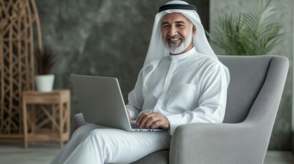 Senior Arab man using laptop at home