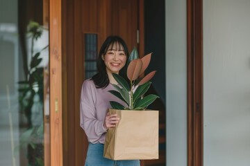 Poster - Woman holding potted plant indoors