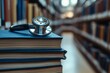 © Unic - A stack of medical books with an out-of-focus stethoscope hanging on the side, symbolizing education and knowledge in medicine